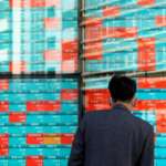 World Shares Mostly Lower in Holiday-Thin Trading, With Half-Day for US Markets