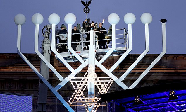 Germany’s chancellor lights first Hanukkah candle on a huge menorah…