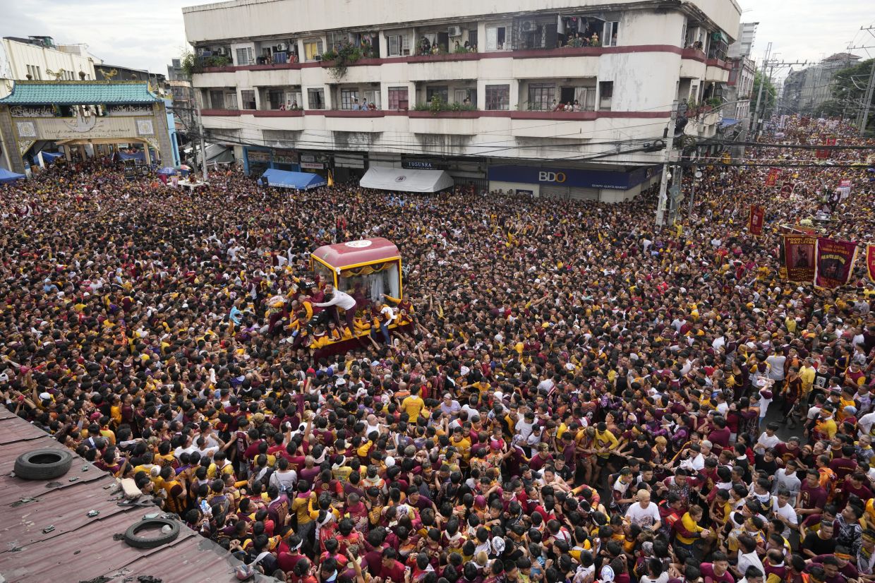 Over one million barefoot devotees flock to feverish Christ icon parade in Philippines