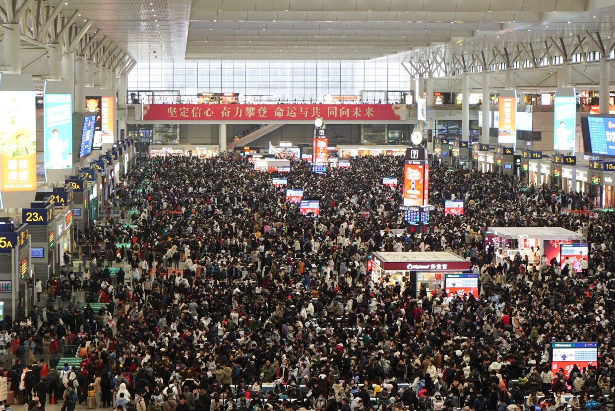 Millions of Chinese endure New Year travel rush for a taste of home