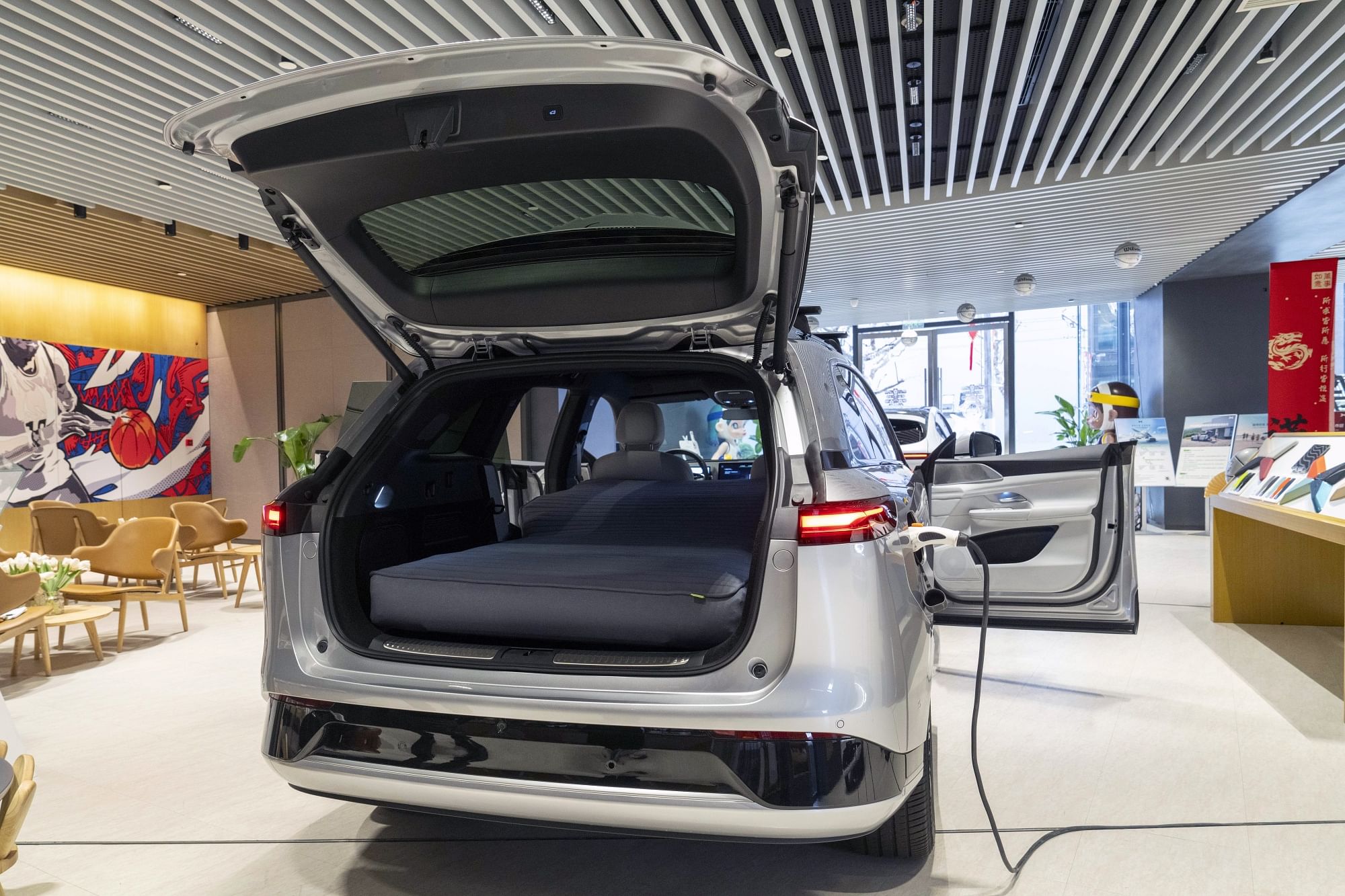 China EV makers woo buyers with in-car beds, kitchens and drones,